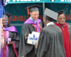 Ryan greeting a graduate.